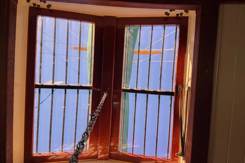 Interior view of a 1983 Bristol Channel Cutter 28, showcasing a wooden-framed window.