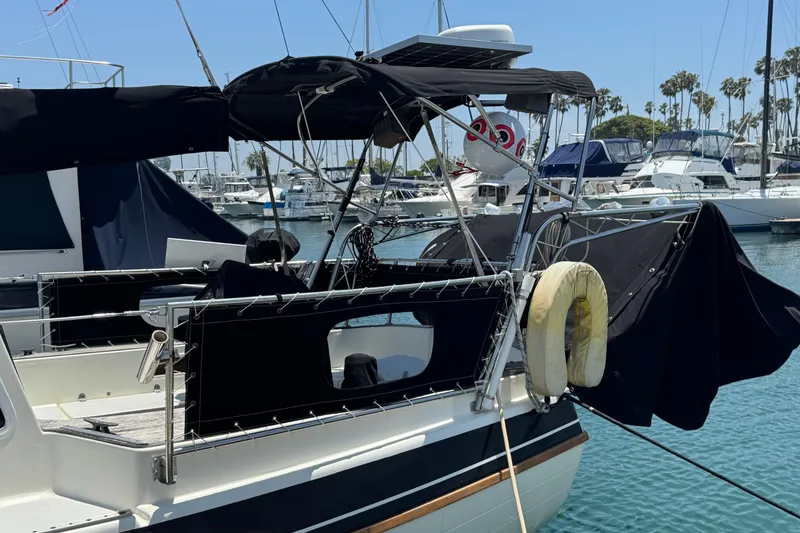 1989 Gulf Pilot House boat docked in marina with other vessels.