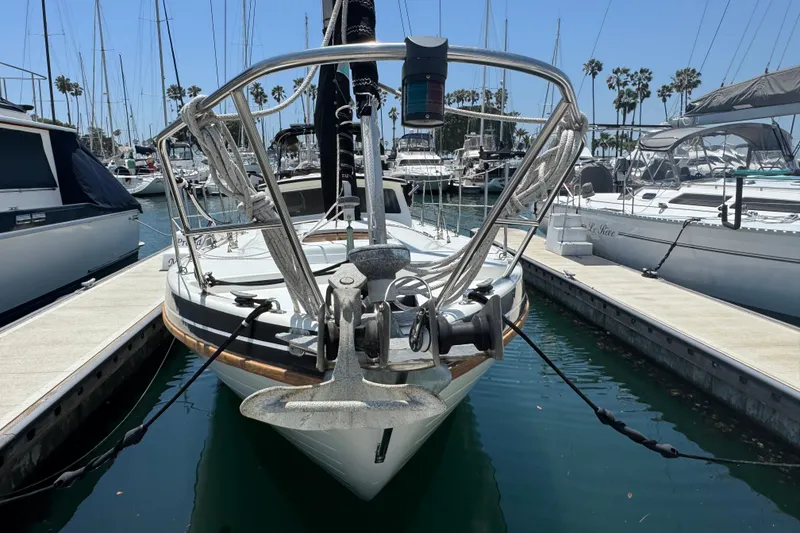 1989 Gulf Pilot House sailboat docked in a marina, surrounded by other boats.