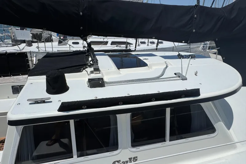 1989 Gulf Pilot House sailboat deck with black sail cover and rigging.