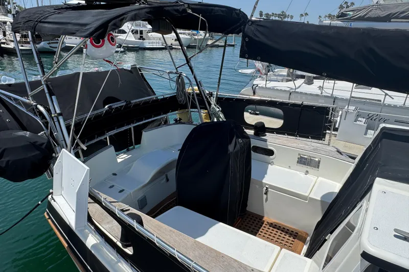 1989 Gulf Pilot House boat docked in marina, featuring covered seating area and nautical equipment.