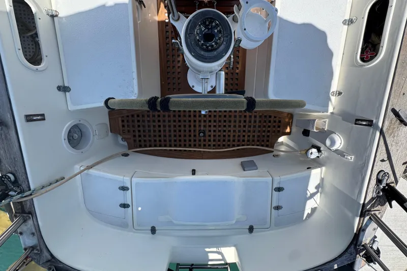 Cockpit of a 1989 Gulf Pilot House boat with steering wheel and navigation instruments.