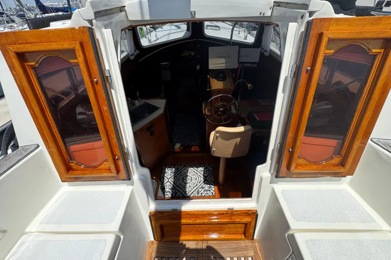 1989 Gulf Pilot House interior with wooden doors and nautical equipment.