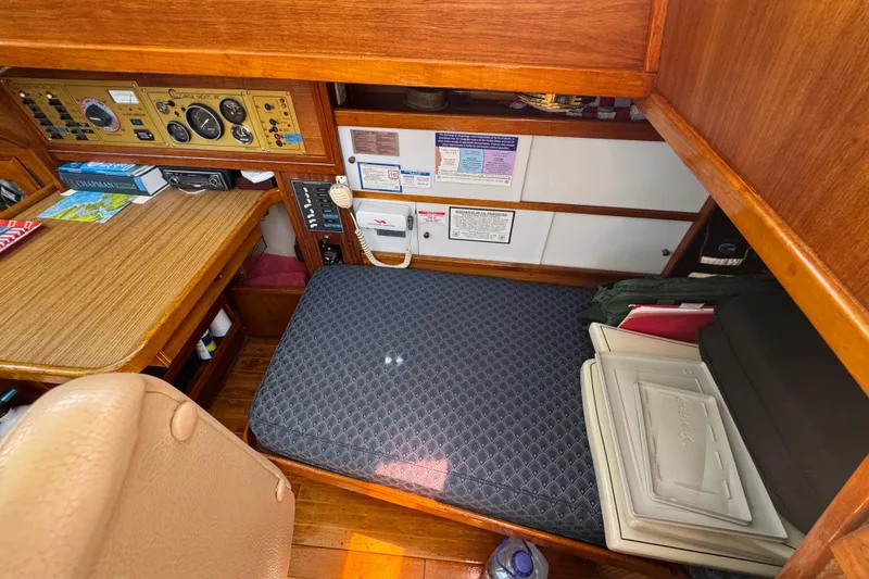 1989 Gulf Pilot House interior with navigation station and cushioned seating area.