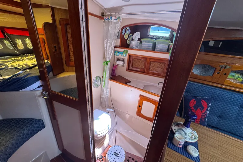 Interior of a 1989 Gulf Pilot House boat featuring a cozy cabin and bathroom.