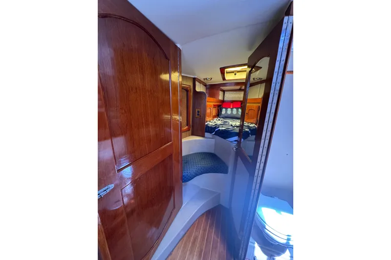Interior of 1989 Gulf Pilot House boat with wooden finishes and cozy sleeping area.