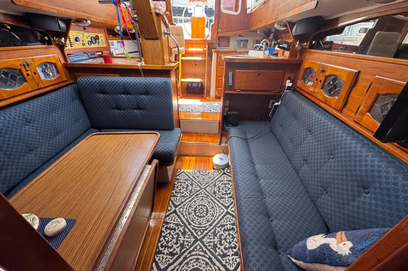 1989 Gulf Pilot House interior with blue upholstery, wooden accents, and nautical decor.