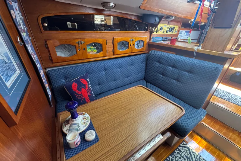 Cozy 1989 Gulf Pilot House interior with blue seating and wooden accents.
