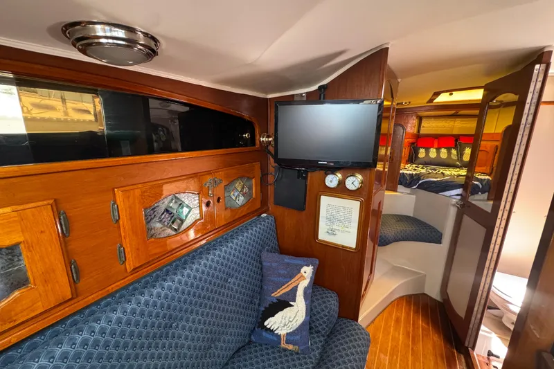 Interior of a 1989 Gulf Pilot House boat with cozy seating and nautical decor.
