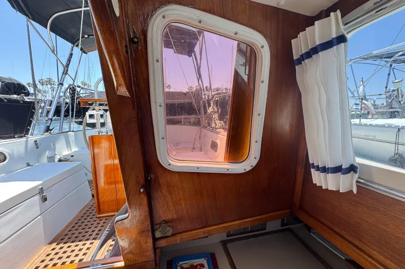 Interior view of 1989 Gulf Pilot House boat with wooden paneling and nautical decor.