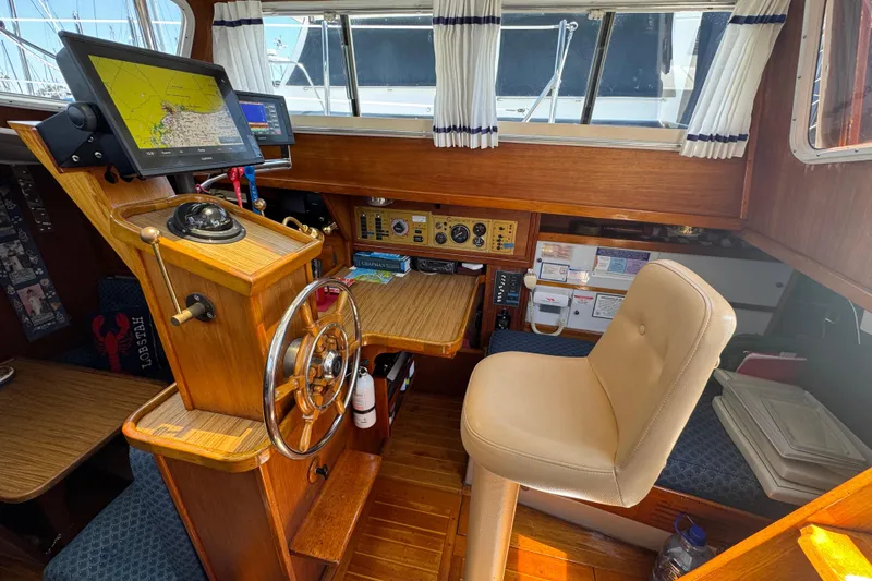 1989 Gulf Pilot House interior with navigation equipment and captain's chair.