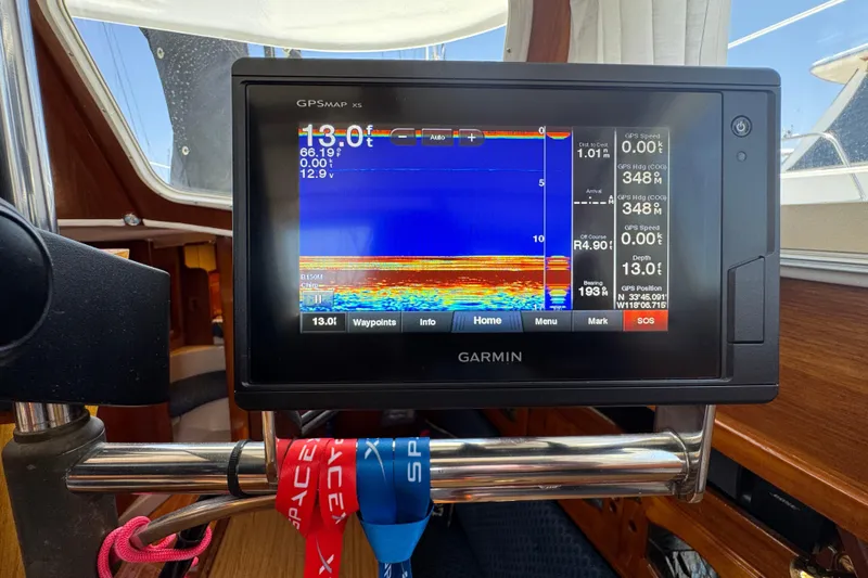 Garmin GPS display on 1989 Gulf Pilot House boat, showing navigation and depth data.