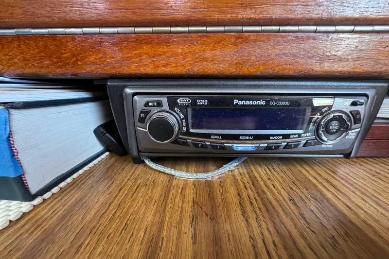 Panasonic car stereo in 1989 Gulf Pilot House, wooden dashboard background.