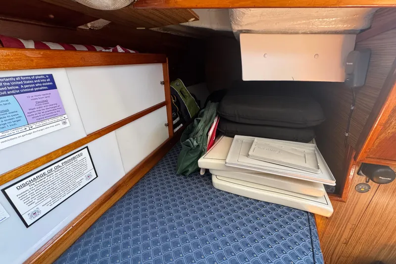 Interior cabin of a 1989 Gulf Pilot House boat with storage and cushions.