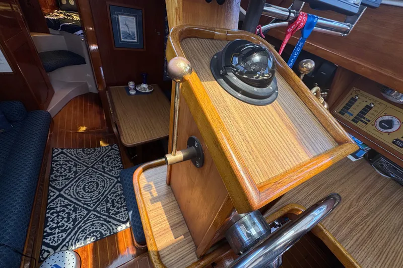 Interior of 1989 Gulf Pilot House boat with wooden helm and nautical decor.