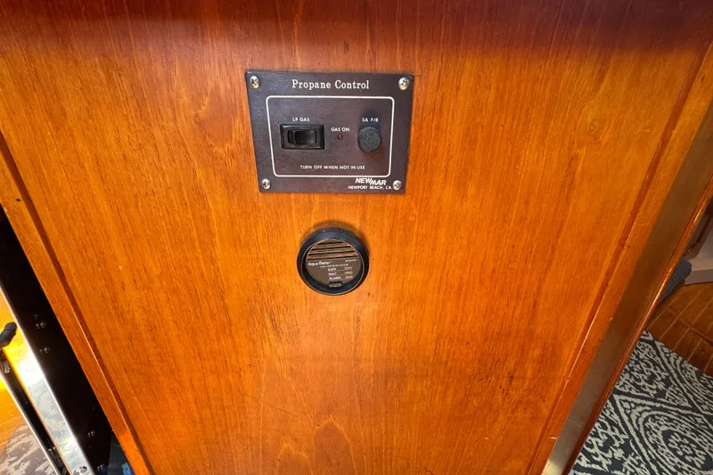Propane control panel on 1989 Gulf Pilot House wooden interior.