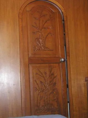 Carved door leads to master head
