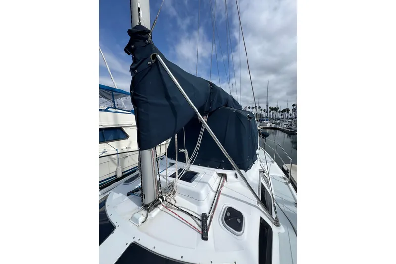 1999 Hunter Passage 420 sailboat with covered mast, docked in marina.