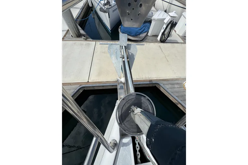 Bow view of a 1999 Hunter Passage 420 sailboat at a dock.