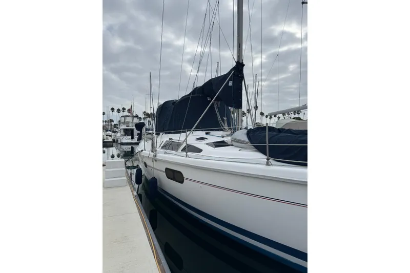 Sailboat docked at marina, 1999 Hunter Passage 420, overcast sky.