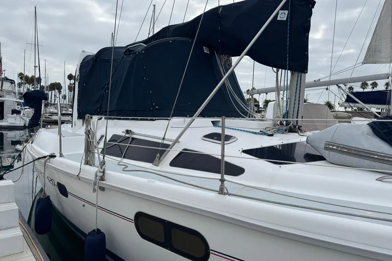 Sailboat Hunter Passage 420, 1999 model, docked at marina with overcast sky.