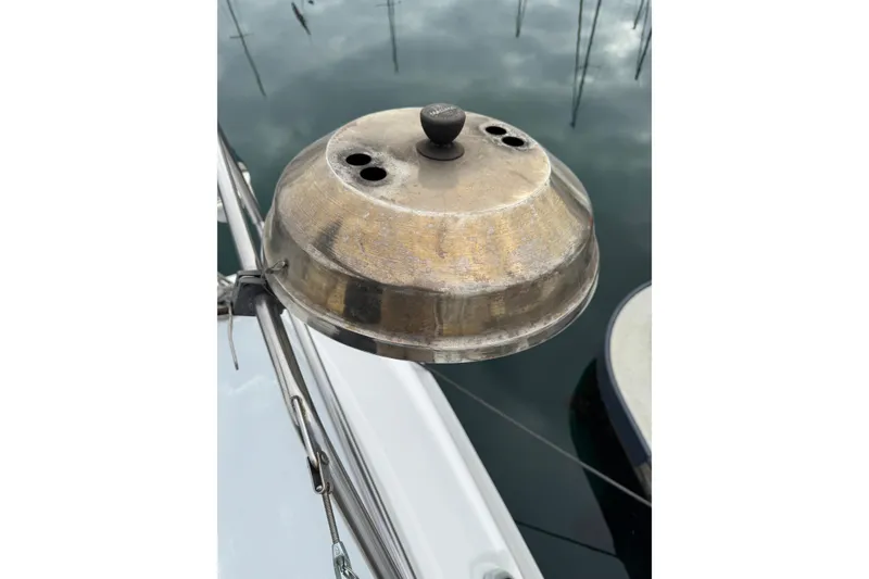 Metallic dome on 1999 Hunter Passage 420 sailboat, reflecting water and sky.
