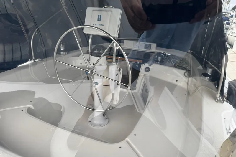 Steering wheel and navigation equipment on 1999 Hunter Passage 420 sailboat.