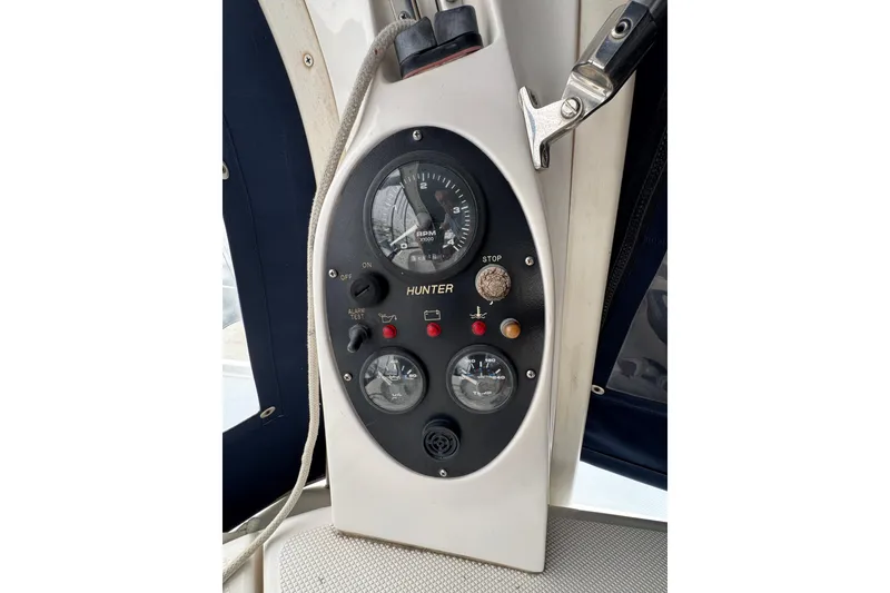 Control panel of a 1999 Hunter Passage 420 sailboat, featuring gauges and switches.