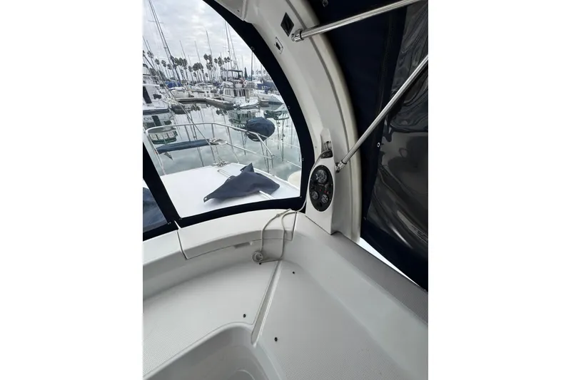 Interior view of 1999 Hunter Passage 420 sailboat cockpit with marina background.