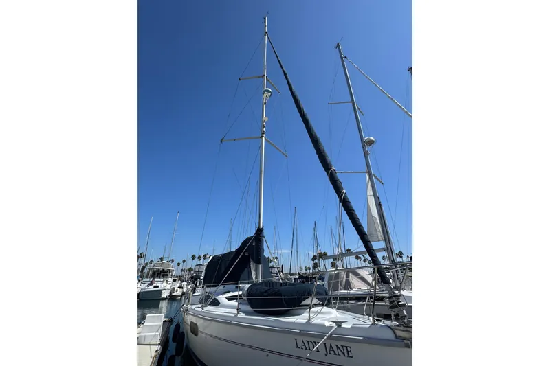 1999 Hunter Passage 420 sailboat docked under clear blue sky.