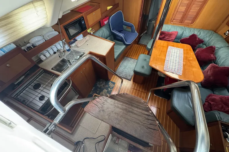 Interior of 1999 Hunter Passage 420 yacht with kitchen and seating area.