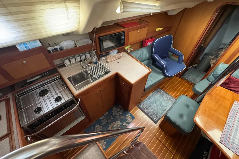 Interior of 1999 Hunter Passage 420 yacht with kitchen and seating area.