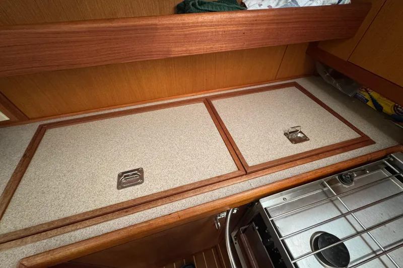 1999 Hunter Passage 420 yacht interior with wooden cabinetry and stove.