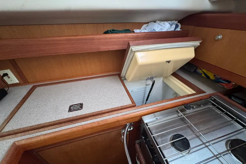 1999 Hunter Passage 420 yacht kitchen with open fridge and stove.
