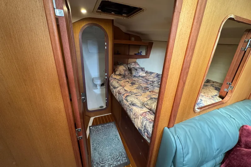 1999 Hunter Passage 420 yacht interior with cozy bedroom and compact bathroom.