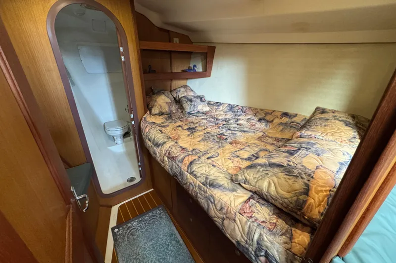 1999 Hunter Passage 420 yacht cabin with bed and private bathroom.