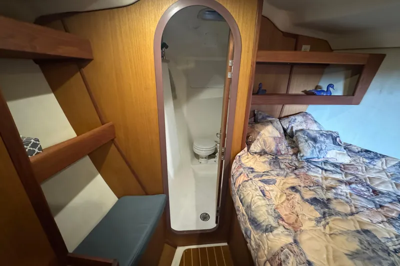 1999 Hunter Passage 420 yacht interior with cozy bed and compact bathroom.