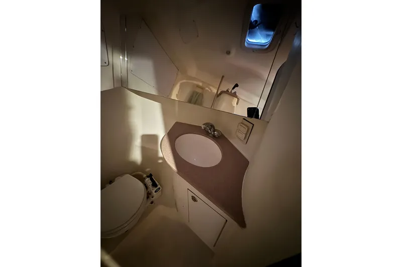 1999 Hunter Passage 420 yacht bathroom with sink, mirror, and toilet.