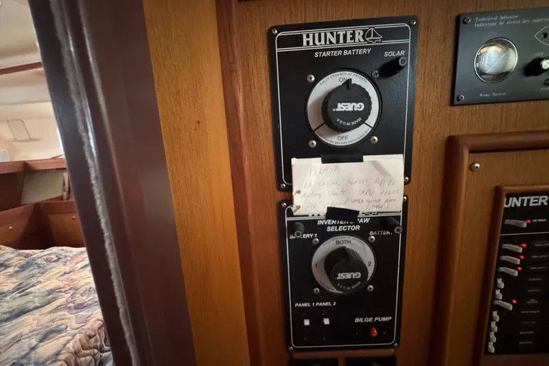Control panel of a 1999 Hunter Passage 420 sailboat with handwritten note.
