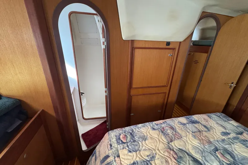 Interior of 1999 Hunter Passage 420 yacht, featuring wood paneling and a cozy cabin.
