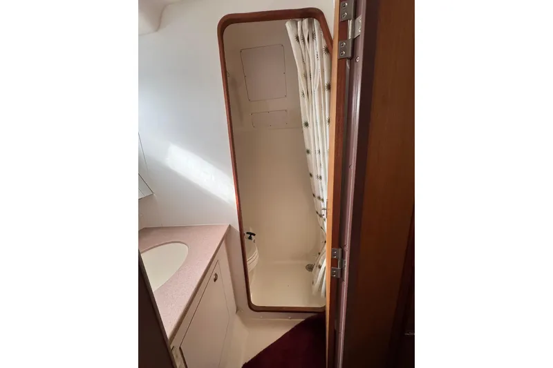 1999 Hunter Passage 420 yacht bathroom with shower and sink.