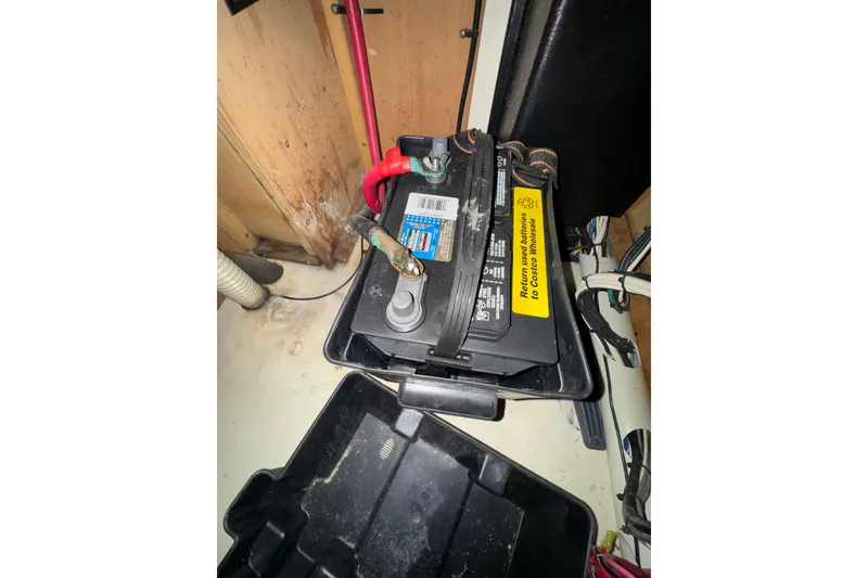 Battery compartment of a 1999 Hunter Passage 420 sailboat, showing wiring and connections.