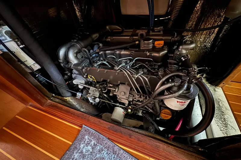 Engine compartment of a 1999 Hunter Passage 420 sailboat, showcasing detailed mechanical components.