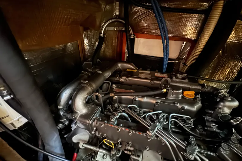 Engine compartment of a 1999 Hunter Passage 420 sailboat, showcasing detailed components.