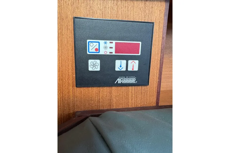 Control panel of a 1999 Hunter Passage 420 yacht, featuring temperature and fan settings.