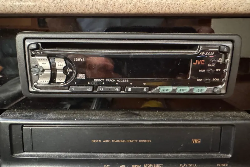 Vintage JVC car stereo and VHS player in a 1999 Hunter Passage 420.