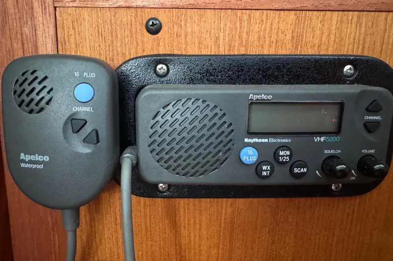 VHF radio system on 1999 Hunter Passage 420 sailboat, featuring Apelco waterproof microphone.