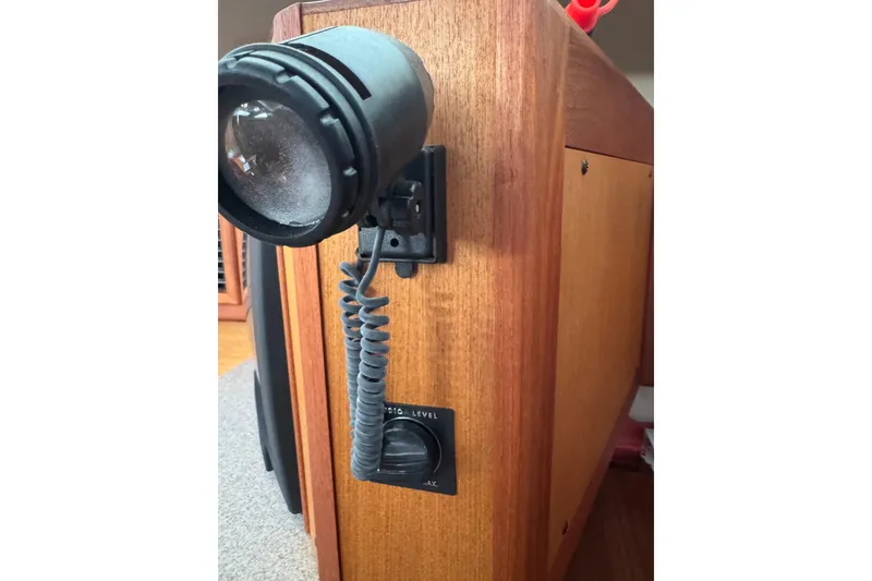 Close-up of a 1999 Hunter Passage 420 interior light fixture and audio control.