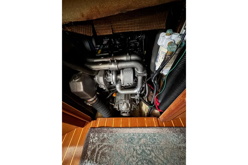 Engine compartment of a 1999 Hunter Passage 420 sailboat, showing detailed mechanical components.