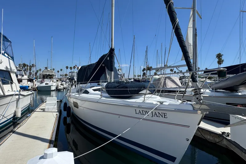 1999 Hunter Passage 420 sailboat docked in marina under clear blue sky.